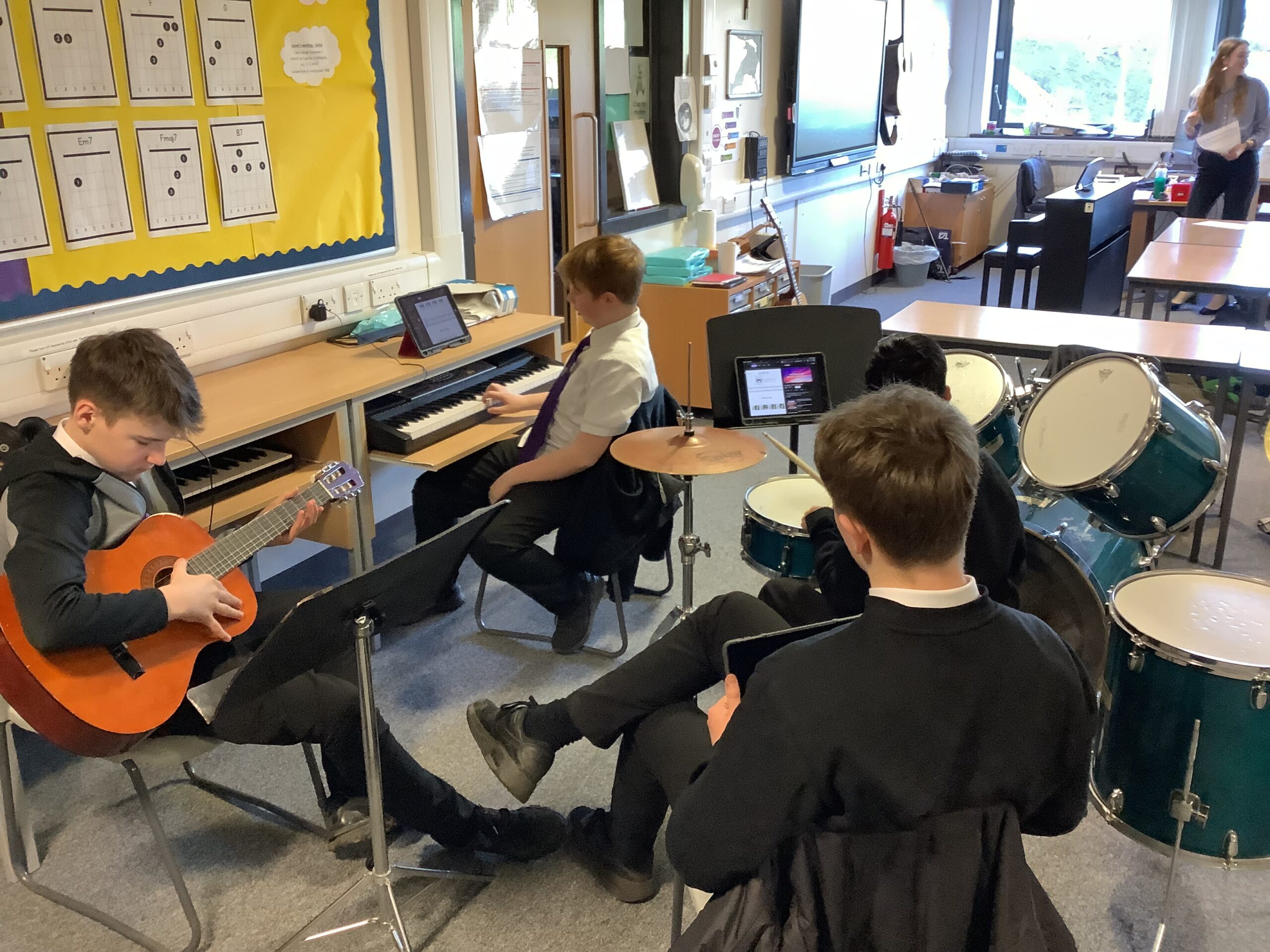 Pupils at Holy Rood High learn to play music together in small groups.